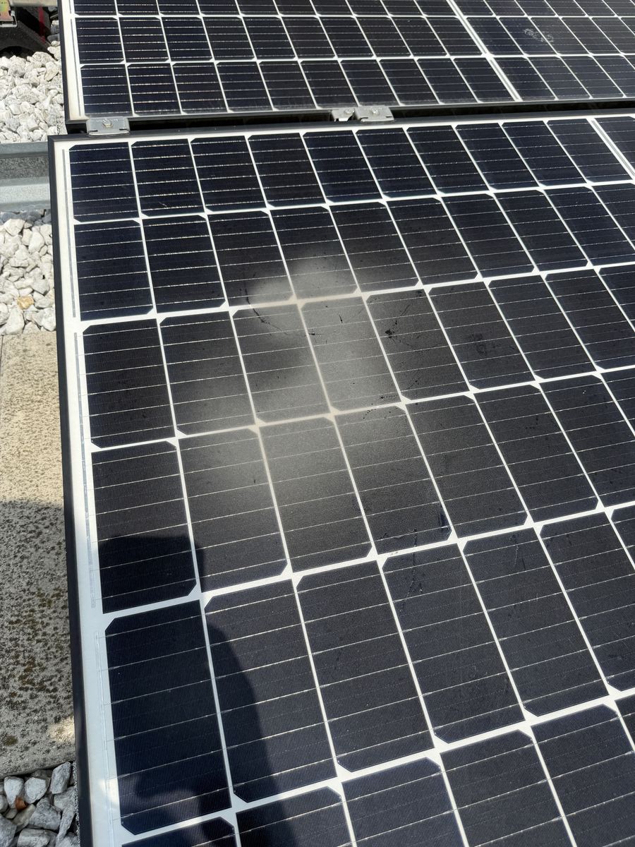 Dust and residue film accumulated across a solar panel surface