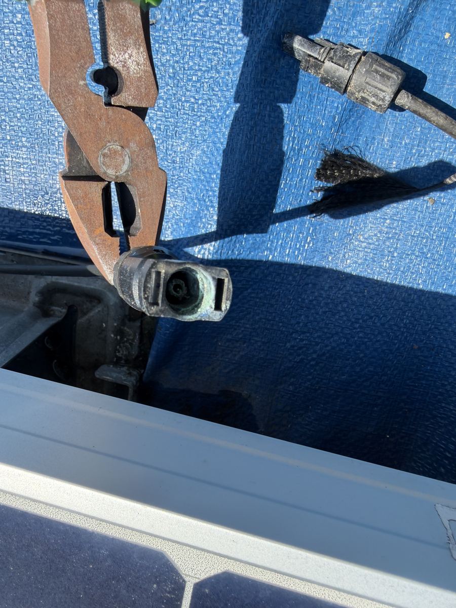 Corroded aluminum conductor strands held with pliers at a lug connection