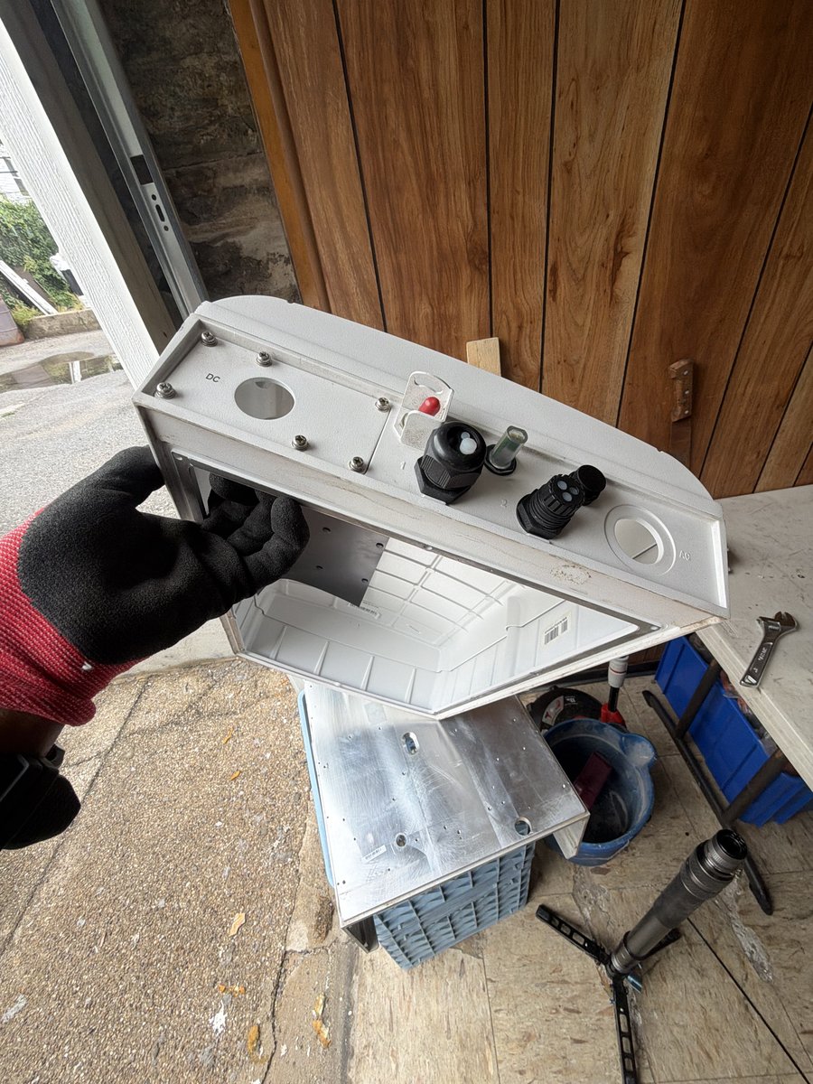 Recovered solar inverter enclosure assembly for repair of a damaged client inverter