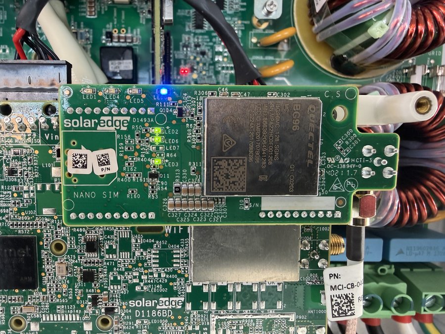 Close-up of a SolarEdge inverter communication board showing WiFi and cellular modem modules used for production monitoring